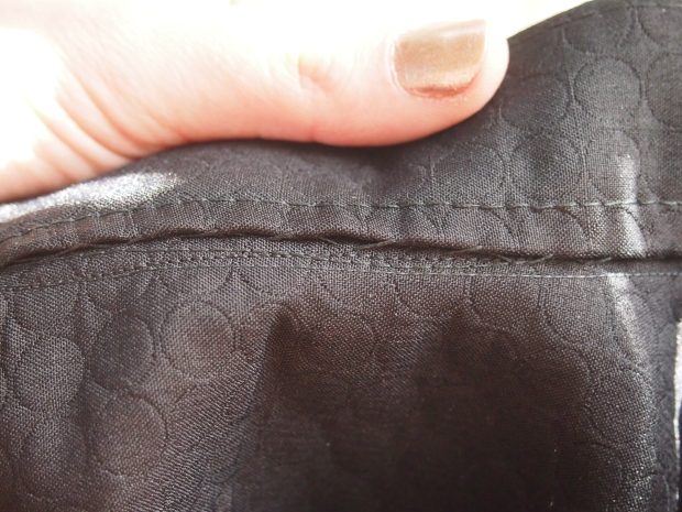 Inside of waistband, handstitched down